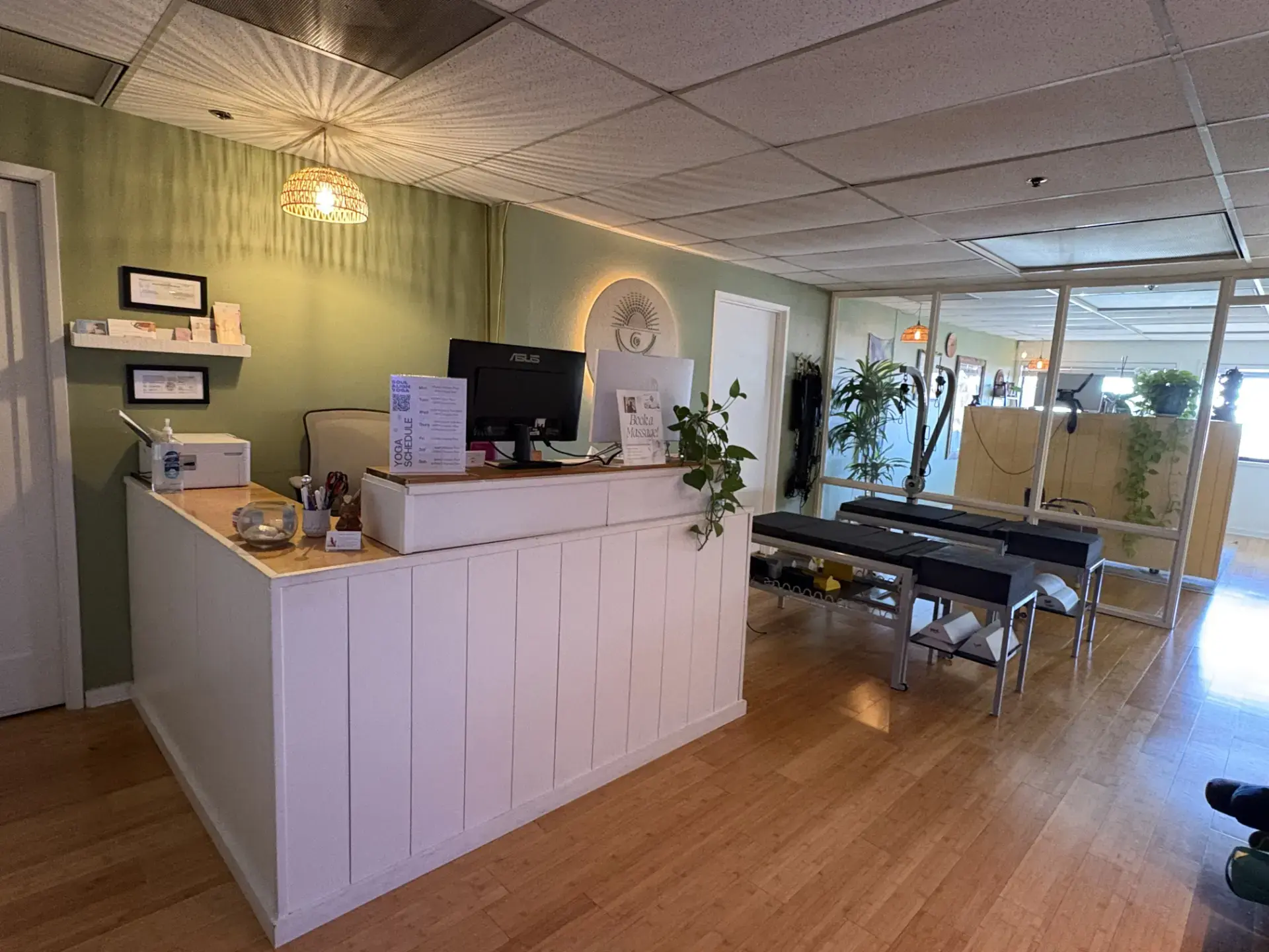 Soul Align front desk with the backlit logo and chiropractic tables beyond